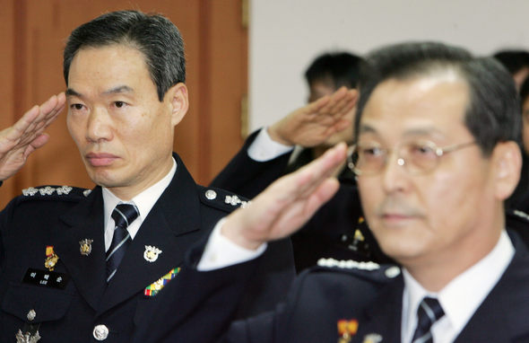 새 경찰청장에 내정된 이택순 경기경찰청장(왼쪽)이 4일 오전 서울 미근동 경찰청에서 열린 ‘전국 경찰 지휘부 회의’에서 국기를 향해 경례하고 있다. 오른쪽은 최광식 경찰청 차장이다. 김정효 기자 <A href="mailto:hyopd@hani.co.kr">hyopd@hani.co.kr</A>
