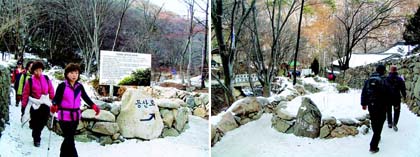 광덕사와 안양암이 차량 진입을 막기 위해 길 가운데 화단을 만들고 등산로와 하산로를 구분해 놓은 등반로로 등반객들이 지나가고 있다.