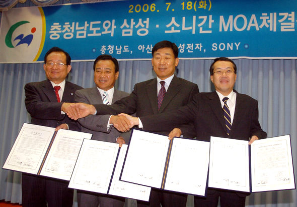18일 충남도청 대회의실에서 강희복 아산시장(왼쪽)과 이완구 충남지사, 장원기 에스-엘시디 사장, 히토미 마사토시 에스-엘시디 수석 재무이사가 투자협정서(MOA)에 서명한 뒤 악수를 하고 있다. 대전/연합뉴스