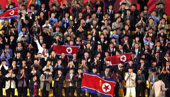 7일 새벽(한국시간) 2006도하아시안게임 남자 축구 북한과 일본의 경기장인 도하 카타르 스포츠클럽 스타디움을 찾은 수백명의 북한 응원단이 질서 정연하게 줄을 맞춰 앉아 응원하고 있다. 한편 카타르에는 쿠웨이트 등에서 송출된 근로자들이 상당수 근무하고 있는 것으로 알려져 있다. (도하=연합뉴스)