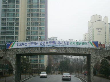 5천여가구의 주민들이 사는 경기 수원시 조원동 ‘한일타운’ 안 쪽 구름다리에 신분당선 연장선의 동시 건설을 촉구하는 아파트 입주자 대표회의 명의의 펼침막이 내걸렸다.