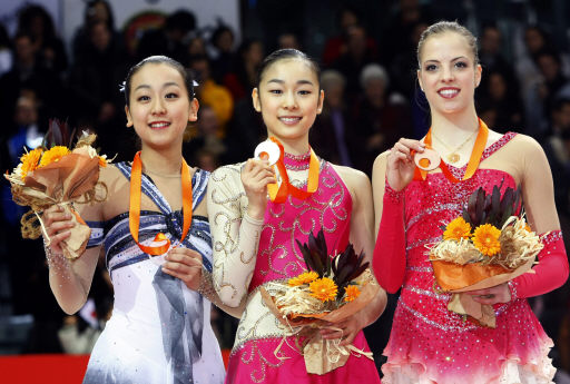 16일 김연아(가운데)가 금메달을 들어보이고 있다. 좌우엔 아사다 마오(2위·일본)와 카롤리나 코스트너(3위·이탈리아). 토리노/AFP 연합