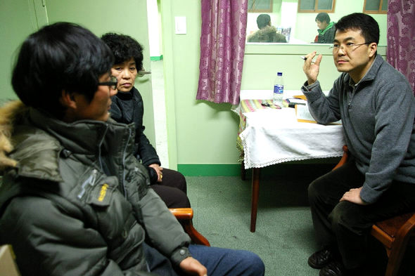  여수외국인보호소 화재 참사에서 가까스로 목숨을 건진 중국인 우건청씨가 27일 오전 서울 가리봉동 이주여성상담소에서 김석현 한양대 의대 교수와 개인면담을 하고 있다. 이주여성상담소 제공