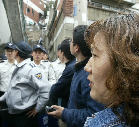22일 오후 안양 초등생 유괴, 살인 피의자인 정씨의 범행에 대한 현장검증이 경기도 안양 정씨의 범행 장소에서 실시되고 있는 가운데 피해 어린이인 혜진양의 어머니가 피의자의 얼굴을 보겠다고 주장하고 있다. (수원=연합뉴스)