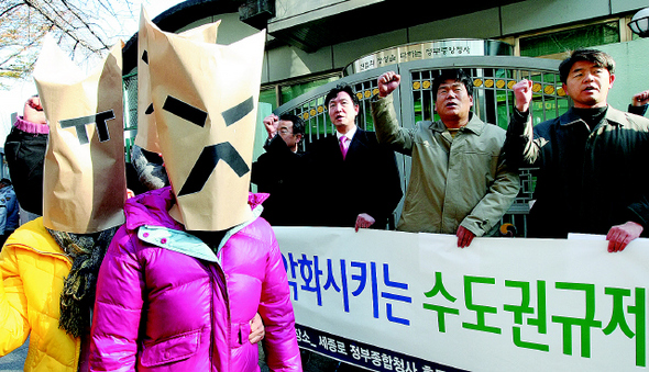수도권 과밀 반대 전국연대 소속 회원들이 20일 오전 서울 세종로 정부종합청사 후문에서 기자회견을 열어 수도권 삶의 질을 악화시키는 수도권 규제완화 정책 중단을 요구하고 있다. 김진수 기자 jsk@hani.co.kr