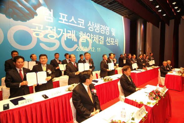 11일 서울 강남 포스코센터에서 열린 ‘범 포스코 상생경영 선포 및 공정거래 협약식’에서 포스코 전 계열사 사장단이 협력업체 대표들과 함께 상생경영 협약서를 들어보이고 있다.   포스코 제공
