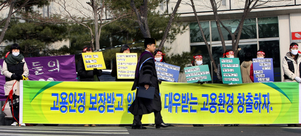  최근 해고를 통보받은 명지대학교 행정 직원들이 18일 오후 이 학교 졸업식이 열린 서울 남가좌동 교정에서 고용 보장을 요구하는 침묵시위를 벌이고 있다. 학교 쪽은 지난 1월 계약기간이 끝난 비정규직 95명에게 해고를 통보했다.   이종근 기자 root2@hani.co.kr