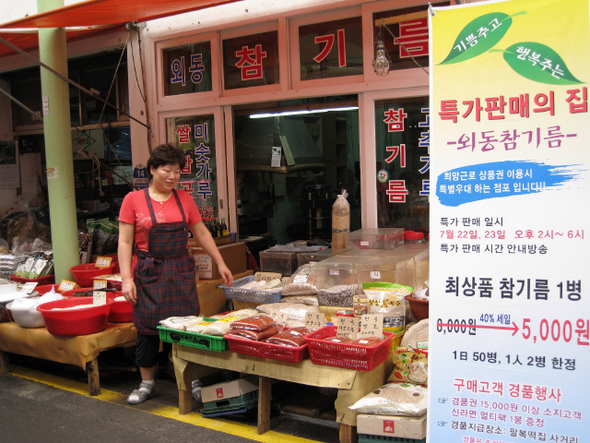 신정시장 설립 30여 년 만에 상인회가 처음으로 여는 역마진 행사에 참여하고 있는 한 상인이 특별할인을 알리는 배너를 내걸고 고객을 기다리고 있다.