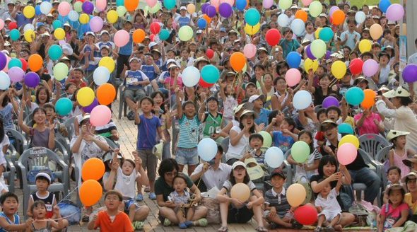 25일 오후 국립과천과학관 앞 마당에서 한국 첫 우주발사체 나로호의 발사 장면을 대형화면을 통해 지켜보던 관람객들이 나로호가 성공적으로 발사되자 환호하고 있다. 연합뉴스