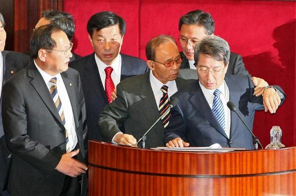 정운찬 총리가 2일 오전 국회 본회의장에서 이명박 대통령의 시정연설을 대독하기 시작하자 이진삼 자유선진당 의원(앞줄 오른쪽 둘째)이 연설 중단을 요구하며 단상에 올라 거세게 항의하고 있다.  연합뉴스