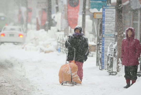 4일 오전 서울, 경기남부에 대설경보가 내려진 가운데 동대문구 경동시장 부근에서 시민들이 버스를 기다리고 있다.  (서울=연합뉴스)