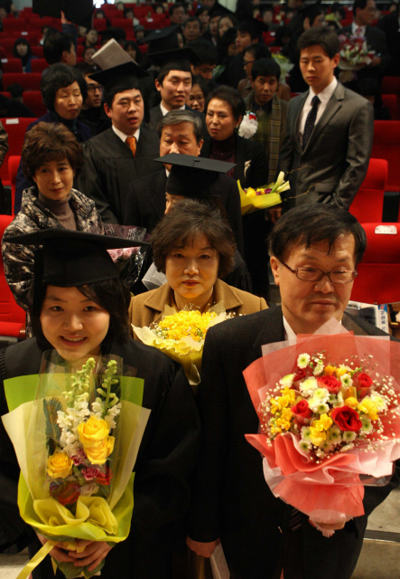  23일 오후 서울 노원구 월계동 광운대학교 문화관에서 열린 2009학년도 학위수여식에서 졸업생들이 부모님과 함께 학위증을 받으려 차례를 기다리며 서 있다. 광운대는 올해 졸업생 가운데 신청자들에게 그동안 자신을 뒷바라지해 준 부모님과 함께 강단에 올라 졸업장을 받는 자리를 마련했다. 김종수 기자 jongsoo@hani.co.kr