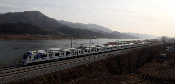 서울 상봉과 강원 춘천을 잇는 경춘선 복선전철이 개통된 21일 오후 서울행 전철이 경기 가평군 대성리 북한강가를 지나고 있다. 상봉에서 춘천까지 급행은 63분, 일반열차는 79분 걸리며, 요금은 2500원(교통카드)으로 수도권 광역전철 요금을 적용했다. 출퇴근 시간대엔 12분, 그 외 시간대와 주말엔 20분 간격으로 서울과 춘천을 오가게 된다.  가평/김태형 기자 xogud555@hani.co.kr