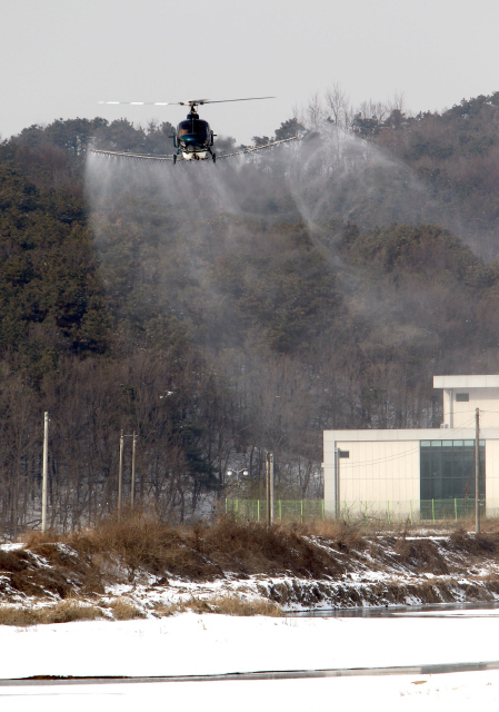 경기 용인시가 구제역과 조류인플루엔자(AI) 확산을 막으려고 3일 오후 임대 헬기로 용인시 처인구 백암면 일대 상공에서 소독액을 뿌리고 있다.  용인/이종근 기자 root2@hani.co.kr