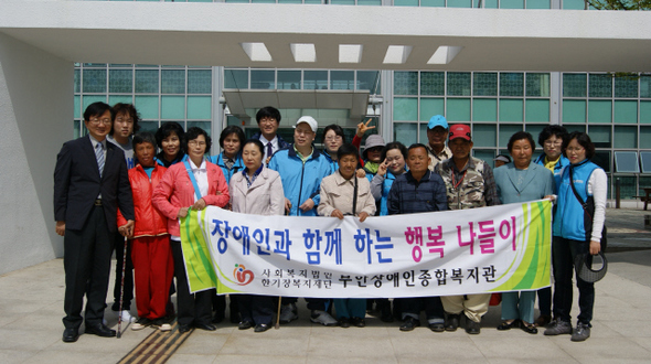 전북 부안지역 중증장애인들과 활동보조인들이 지난 4일 전주국제영화제를 보려고 출발하기 앞서 복지관 앞에서 기념사진을 찍었다.  부안 장애인종합복지관 제공