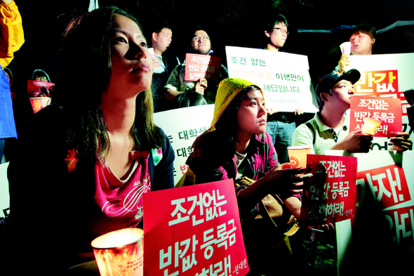 한국대학생연합 소속 학생들이 31일 밤 서울 광화문 케이티 앞 인도에서 등록금 반값 공약 이행을 촉구하는 촛불시위를 벌이고 있다. 이정우 선임기자 <A href="mailto:woo@hani.co.kr">woo@hani.co.kr</A>