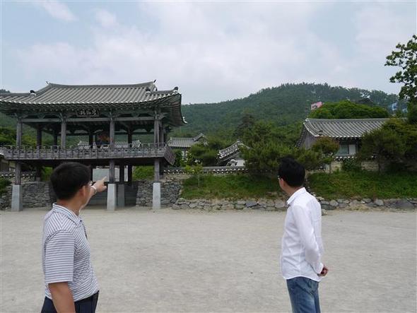 전북 부안군 변산면 궁항의 지구단위계획을 반대하는 주민이 드라마를 촬영했던 이순신 세트장과 고급 호텔 건설 예정지를 가리키고 있다.