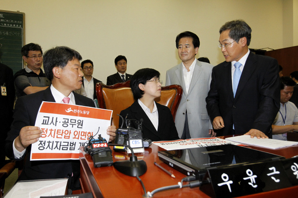 우윤근 국회 법제사법위원회 위원장(맨 오른쪽)이 30일 오전 입법로비를 가능하게 만든 정치자금법 개정안 처리를 막기 위해 위원장석을 점거한 민주노동당 이정희 대표와 김선동 의원(맨 왼쪽)에게 정치자금법을 통과시키지 않겠다고 말하고 있다. 김명진 기자 littleprince@hani.co.kr