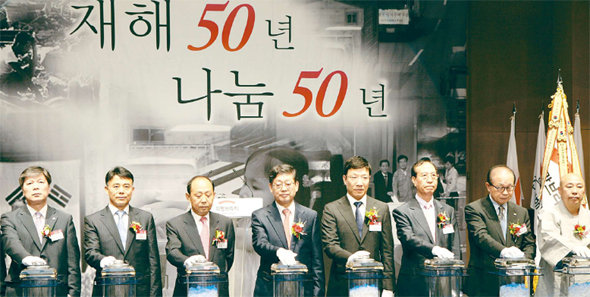 13일 오전 서울 중구 태평로 한국언론회관에서 열린 전국재해구호협회(회장 최학래) 창립 50돌 기념식에서 김황식 국무총리를 비롯한 주요 참석자들이 ‘희망브리지’라는 협회의 새로운 로고를 처음 공개하는 스위치를 누르고 있다. 전국재해구호협회 제공