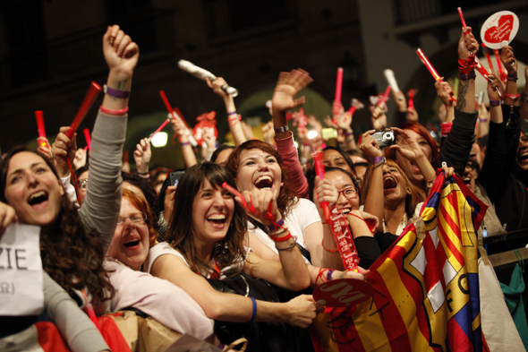 Members of K-pop group JYJ wave as European fans cheer during their concert in Barcelona, Spain, Oct. 29.