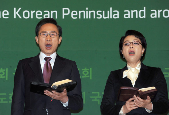 이명박 대통령과 부인 김윤옥씨가 8일 오전 서울 서대문구 홍은동 그랜드힐튼호텔 컨벤션홀에서 열린 국가조찬기도회에서 찬송가를 부르고 있다. 청와대사진기자단