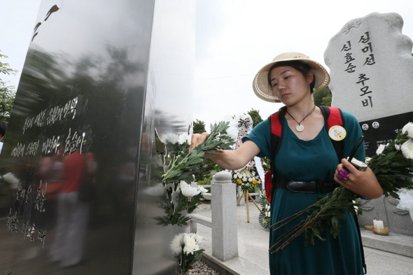  ‘미선·효순양 사고 10주기 추모제’가 열린 13일 오전 경기도 양주시 광적면 효촌리 지방도로 56번 사고현장 주변에서 한 참가자가 두 소녀를 추모하는 조형물 ‘소녀의 꿈’에 국화꽃을 꽂고 있다. 10주기를 기념해 만들어진 조형물은 설치 부지를 마련하지 못해 이날 서울 서대문구 충정로 한국기독교장로회총회 선교교육원에 임시로 설치됐다.  양주/김태형 기자 xogud555@hani.co.kr