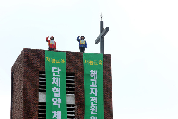 재능교육 해고노동자 오수영(왼쪽) 여민희 씨가 6일 오전 재능교육 본사를 마주보고 있는 서울 종로구 혜화동 성당 종탑에 올라 고공농성에 돌입해 `원직 복직과 단체협약 체결을 촉구하고 있다. 한겨레 이정아 기자 leej@hani.co.kr