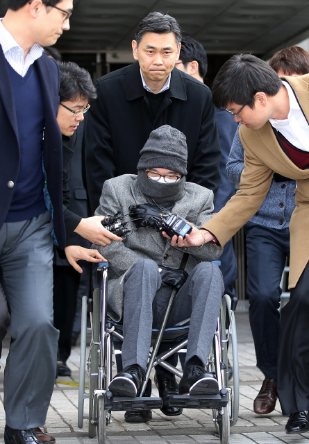 휠체어에 탄 이재현 씨제이(CJ) 회장이 14일 오후 서울중앙지방법원에서 수천억원대의 비자금을 운용하면서 수백억원의 조세를 포탈한 혐의에 대해 징역 4년, 벌금 260억원의 1심 선고를 받은 뒤 기자들의 질문을 피해 법원을 빠져나가고 있다. 이정아 기자 leej@hani.co.kr