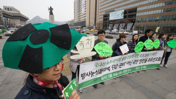 녹색당 당원들이 19일 오전 서울 광화문광장 이순신동상 앞에서 ‘국내산 녹차 방사성 물질 검출’과 관련한 기자회견을 열어  녹차뿐만 아니라 다른 국내산 잎채소 등 대중적 먹거리에 대한 방사능 오염과정과 유통경로를 공개할 것을 요구하고 있다. 녹색당은 식품의약품안전처의 2013~2014년 ‘국내 유통식품 방사능 검사결과’를 확인한 결과, 2013년 대전청 검사 중 국내산 녹차 2건에서 세슘이 각각 ㎏당 7베크렐, 2베크렐 검출된 것으로 드러났다고 밝혔다. 김성광 기자 flysg2@hani.co.kr