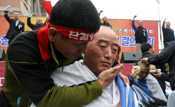<b>“강제전출 말라” 철도노조원 삭발</b> 29일 오후 서울시 용산구 서울역 광장에서 열린 ‘전국철도노동조합 총파업 총력투쟁 결의대회’에서 코레일의 ‘4월 초 850여명 순환전보’ 방침을 ‘보복성 강제전출’이라며 항의하는 삭발식이 열렸다. 머리를 깎아준 한 조합원이 삭발한 동료의 얼굴을 안타까운 표정으로 감싸고 있다. 이날 삭발식에는 100여명의 조합원이 참여했다. 이정우 선임기자 woo@hani.co.kr