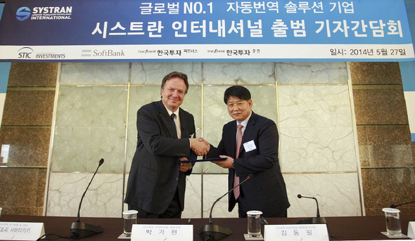 박기현(오른쪽) 씨에스엘아이 대표와 디미트리 사바타카키스 시스트란 회장이 27일 서울 플라자호텔 다이아몬드룸에서 회사 인수 계약서에 서명한 뒤 악수를 하고 있다. 씨에스엘아이 제공