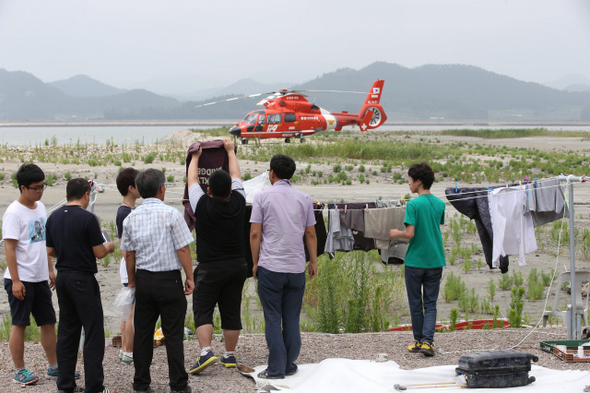 태풍 ‘너구리’가 다행히도 별 탈 없이 지나간 10일 오후 진도 팽목항엔 바람이 멈추고 먹구름이 걷혔다. 진도군청 직원들과 대학생 아르바이트 학생들이 바닷속 세월호에서 건져 올린 단원고 학생들과 실종자들의 유류품을 물로 씻은 뒤 햇볕에 말려 가지런히 정리하고 있다. 주인 잃은 옷가지는 바닷바람에 뒤척이며 주인을 기다린다. 세월호가 침몰한 지 석 달이 되어간다. 11명의 실종자들이여 어서 돌아오시길.
  진도/김봉규 선임기자 bong9@hani.co.kr