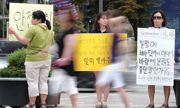 3일 오후 서울 광화문광장 세월호 희생자 유가족 단식농성장 주변에서 시민단체 회원들이 ‘세월호를 잊지 말아주세요’라고 쓴 손팻말을 들고 ‘세월호 특별법’ 제정을 촉구하고 있다. 
이정용 기자 lee312@hani.co.kr