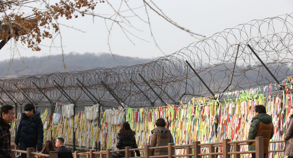 경기도 파주시 문산읍 임진각을 찾은 시민들이 4일 오후 평화와 통일의 염원이 담긴 리본이 겹겹이 매달린 철책 앞을 지나가고 있다. 파주/김봉규 기자 bong9@hani.co.kr