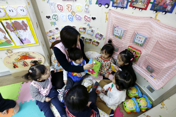 4살 어린이들이 9일 오전 서울시 동대문구 답십리동 구립 대림늘푸른어린이집에서 보육교사의 구연동화를 들으며 활짝 웃고 있다. 나이를 묻자 어린이들이 손가락 다섯 개를 활짝 펴 보이고 있다. 이 어린이집은 2004년 민간 어린이집으로 개원했으나 2012년 국공립으로 전환했다.   이정아 기자 leej@hani.co.kr