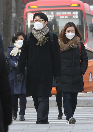 긴 설 연휴를 보낸 시민들이 23일 오전 서울 종로구 광화문 네거리에서 몽골 남부와 중국 북부지역에서 발원한 황사를 염려해 입 가리개를 한 채 출근을 하고 있다. 신소영 기자 viator@hani.co.kr