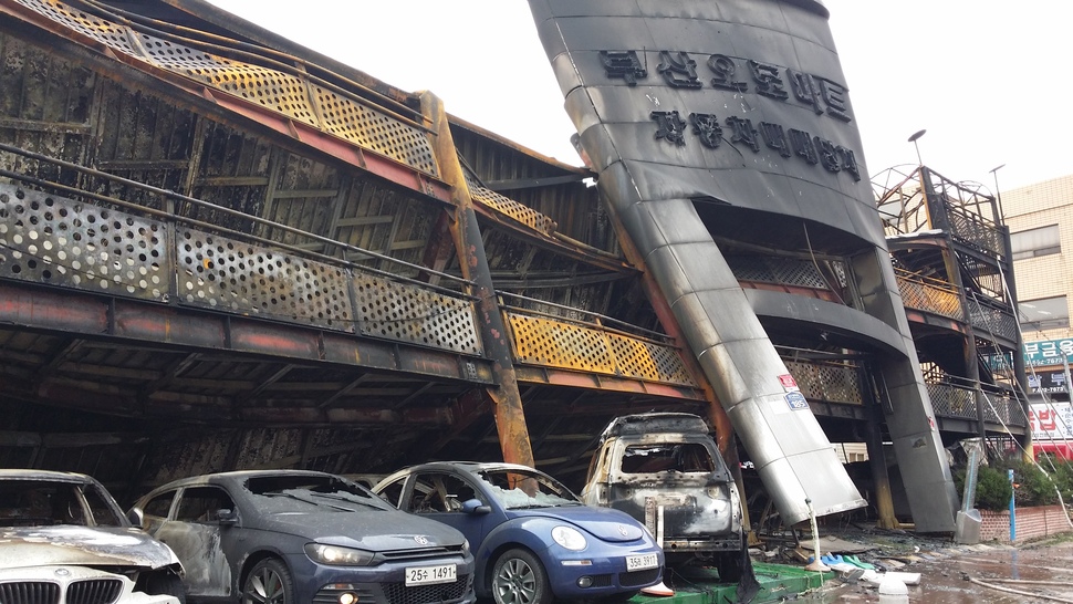 3일 새벽 1시53분께 부산 연제구 거제동에 있는 ㅂ중고차매매단지에서 불이 나 차량 570여대가 불에 탔다. 이날 불로 주차장 2·3층 철제 바닥이 불에 녹아 휘어져 땅으로 내려앉았다. 매매단지 들머리 쪽에 주차된 수입차들이 불에 탄 채 부서져 있다. 부산/김영동 기자 ydkim@hani.co.kr