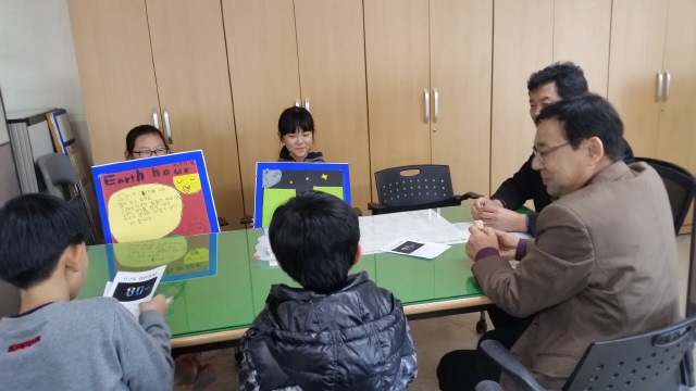 지구 시간 지키기 캠페인을 위해 관공서를 방문한 전남 영광 불갑초 학생들이 공무원들과 함께 이야기를 하는 모습. 　박영민 교사 제공