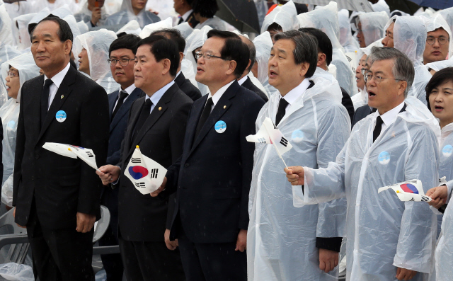 5·18 민주화운동 35주년 기념식이 열린 18일 오전 광주시 북구 운정동 국립 5·18 민주묘지에서 문재인 새정치민주연합 대표(앞줄 맨 오른쪽부터), 김무성 새누리당 대표, 정의화 국회의장이 ‘임을 위한 행진곡’을 따라 부르고 있다. 정부 쪽에서 참석한 최경환 국무총리 대행(앞줄 왼쪽 둘째)과 박승춘 보훈처장(앞줄 맨 왼쪽)은 입을 굳게 다물고 있다. 
 광주/이정용 선임기자 lee312@hani.co.kr
