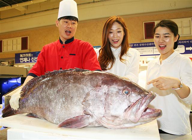 21일 오전 부산 동래구 메가마트 동래점 직원들이 ‘전설의 심해어’로 불리는 대형 돗돔 1마리(길이 1.1ｍ, 무게 80㎏)를 선보이고 있다. 메가마트는 이 돗돔을 횟감용으로 해체한 뒤 400ｇ(2~3인분)당 5만원에 선착순 판매한다.  메가마트 제공