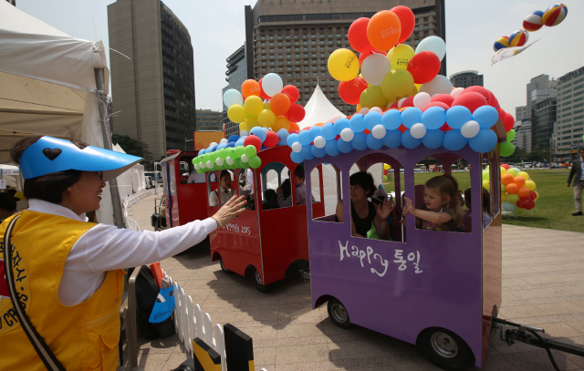  29일 오전 서울 광화문광장에서 열린 ‘광복 70년 기념 통일박람회 2015’ 행사에서 시민들이 서울~개성~평양~런던역을 연결한다는 의미의 ‘통일열차’를 타고 행사장을 돌고 있다.   신소영 기자 viator@hani.co.kr