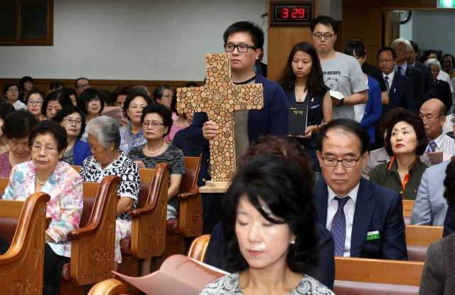 한국기독교교회협의회(NCCK) 화해·통일위원회가 주최하는 ‘2015년 세계교회와 함께하는 광복 70주년 한반도 평화통일 공동기도주일 연합예배’가 9일 낮 서울 은평구 응암동 서문교회에서 열리고 있다. 이 예배는 2013년 세계교회협의회(WCC) 제10차 부산총회에서 ‘한반도 평화통일을 위한 성명서’를 채택하고 매년 8월15일 직전 주일을 ‘한반도 평화통일 공동기도주일’로 지정해 세계 교회가 참여하기로 결의한 데 따른 것이다. 예배를 시작하며 조화와 평화·일치를 이루는 교회공동체의 모습을 담은 ‘한 몸 십자가’ 뒤로 남쪽 성경과 북쪽 성경(조선그리스도교연맹이 번역하고 북한 교회가 실제 사용하는 성경)을 든 신도들이 입장하고 있다.   강재훈 선임기자 khan@hani.co.kr