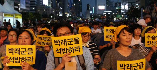 열대야의 열기로 후텁지근한 도심 한복판에서 시민들이 영상을 보고 있다. 지난 8일 밤 서울 광화문광장. 평택 대추리에서 또 용산에서 쫓겨나는 이들 편에 선 데 이어, 세월호 진상규명 집회를 주도했다는 이유로 인권운동가 박래군이 열두번째 구속되는 장면에서 시민들의 눈시울이 붉어진다. “우리가 박래군의 발이 되고 입이 되어 더 많은 박래군으로 살아갈 것이다. 세월호의 진실이 모두 밝혀지고, 박래군이 우리 품으로 돌아올 때까지 우리는 모두 박래군이 될 것이다.” 박씨의 학우들인 연세대 국문과 동문들이 낸 성명이다.  이정우 선임기자 woo@hani.co.kr