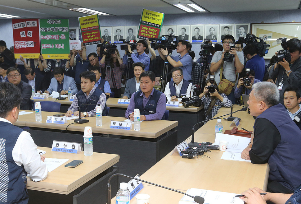 14일 오후 서울 여의도 한국노총 대회의실에서 김동만 위원장이 중앙집행위원회의에서 최근 노사정 대타협에 대한 논의에 앞서 머리 발언을 하고 있다. 회의장 뒤로 합의에 반대하는 조합원들이 손팻말을 들고 있다. 김태형 기자 xogud555@hani.co.kr