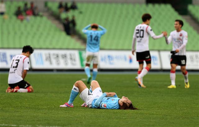대구FC 선수들이 22일 K리그 챌린지 부천FC와의 경기에서 무승부를 기록해 K리그 클래식 직행이 무산되자 그라운드에 누워 아쉬워하고 있다. 대구/연합뉴스