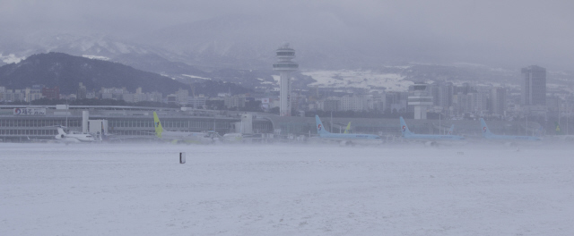 제주 도심에 32년 만에 폭설이 내려 24일 오후 제주시 용담2동 제주국제공항 계류장과 활주로가 눈에 뒤덮여 있다. 이날 한국공항공사 제주지역본부는 폭설과 난기류로 23일 오후 5시50분에 내린 활주로 운영 중단 결정을 25일 오후 8시까지 연장한다고 밝혔다. 국내 공항 활주로가 사흘 동안 폐쇄된 것은 처음 있는 일이다. 제주/김성광 기자 <A href="mailto:flysg2@hani.co.kr">flysg2@hani.co.kr</A>