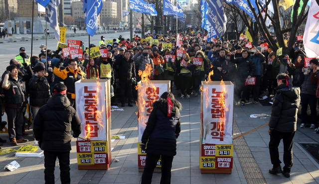 민주노총 조합원들이 27일 오후 서울 사직동 세종로공원에서 열린 ‘노동개악 저지! 정부지침 분쇄! 민주노총 총파업대회’에서 ‘노동탄압’, ‘행정지침’, ‘노동법 개악’ 등이 적힌 상징물을 불태우고 있다. 민주노총은 이날 수도권 등 전국 14개 지역에서 총파업 대회를 열었다.  김경호 선임기자 jijae@hani.co.kr