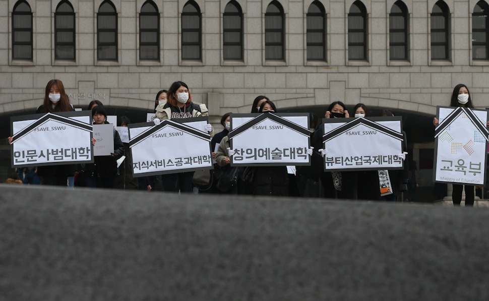 2일 오후 서울 성북구 성신여대에서 재학생 100여명이 마스크를 쓰고 통폐합 되는 학과의 장례식을 상징하는 침묵시위 연 뒤 기자회견이 열리는 정문 앞으로 행진하고 있다. 신소영 기자 viator@hani.co.kr