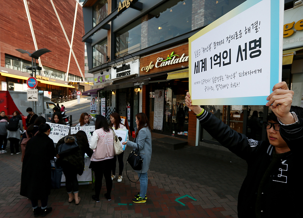 16일 오후 서울 서대문구 이화여자대학교 정문 앞에서 열린 ‘일본군 위안부 문제 해결을 위한 평화나비 캠페인’에서 평화나비네트워크 이화나비 소속 대학생들이 시민들에게 서명을 받고 있다. 연합뉴스