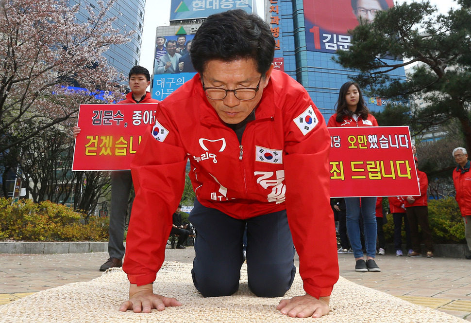 새누리당 김문수 후보(대구 수성갑)가 6일 오후 대구 수성구 범어네거리 자신의 선거 사무소 앞에서 ‘새누리당의 오만함을 사죄드린다‘는 피켓을 세워두고 시민들에게 절을 하며 용서를 구하고 있다. 연합뉴스